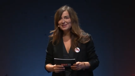 Moderatorin auf der Bühne beim Volkshilfe-Symposium gegen Kinderarmut 2023.